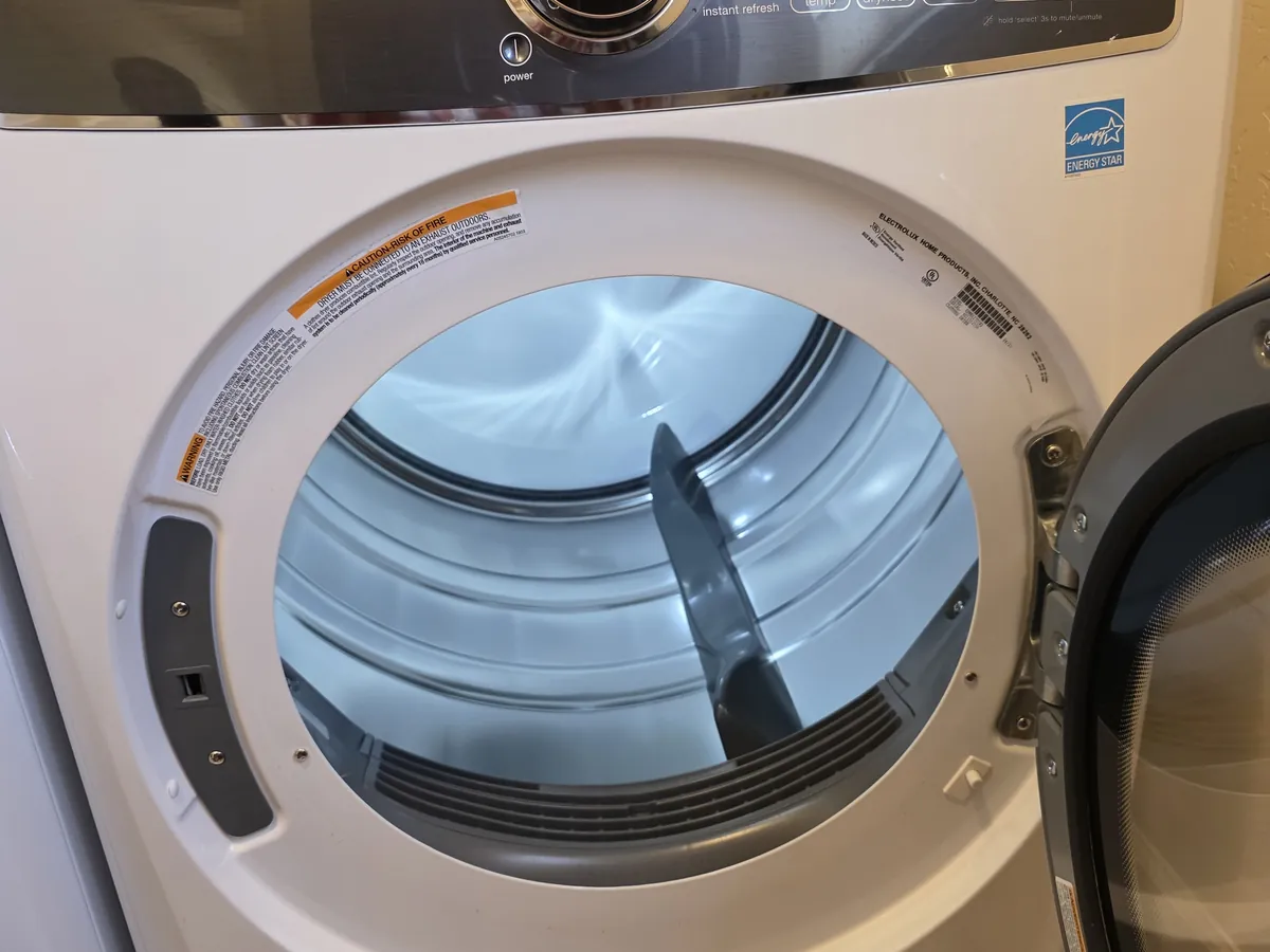 Front-load dryer with the door open in a Bay Area laundry room