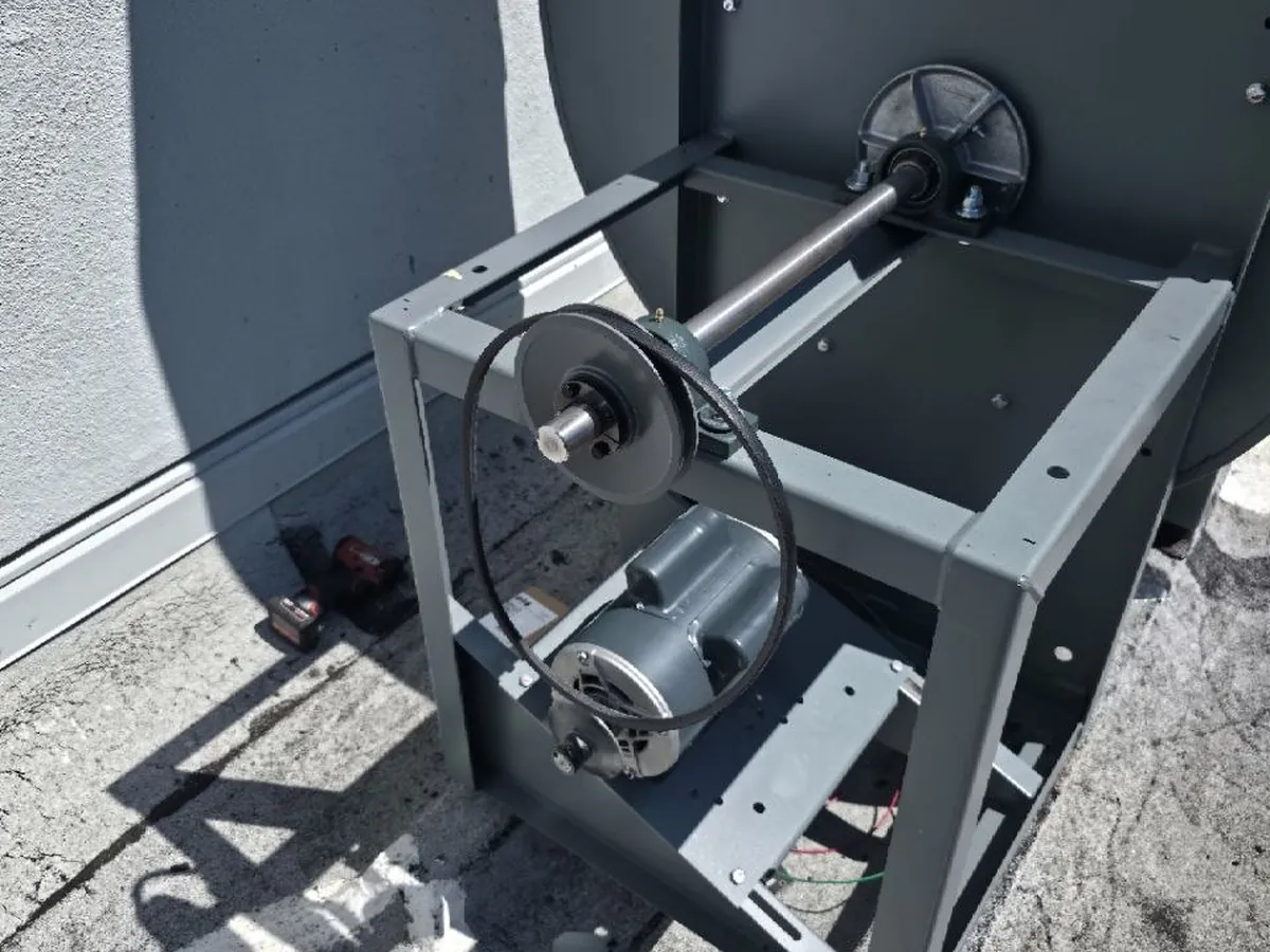 Commercial exhaust fan assembly removed for service