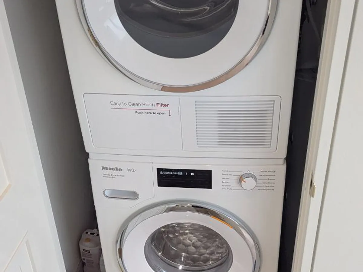 Miele washer and dryer stacked in a Bay Area laundry closet