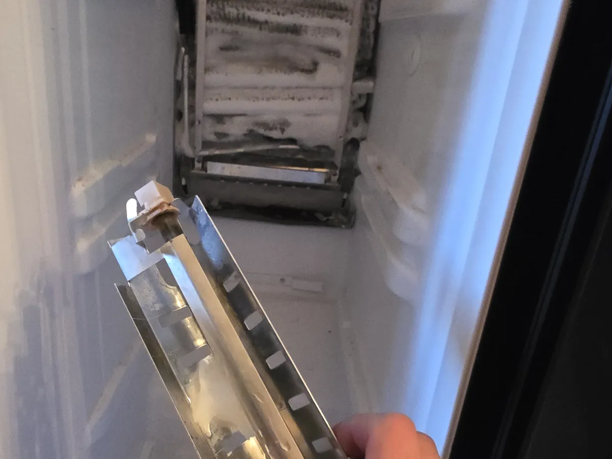 Evaporator cover removed from a refrigeration unit during diagnosis