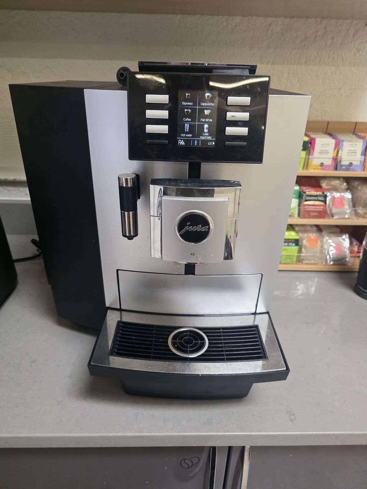 Jura automatic coffee machine with a touchscreen and dispensing spouts