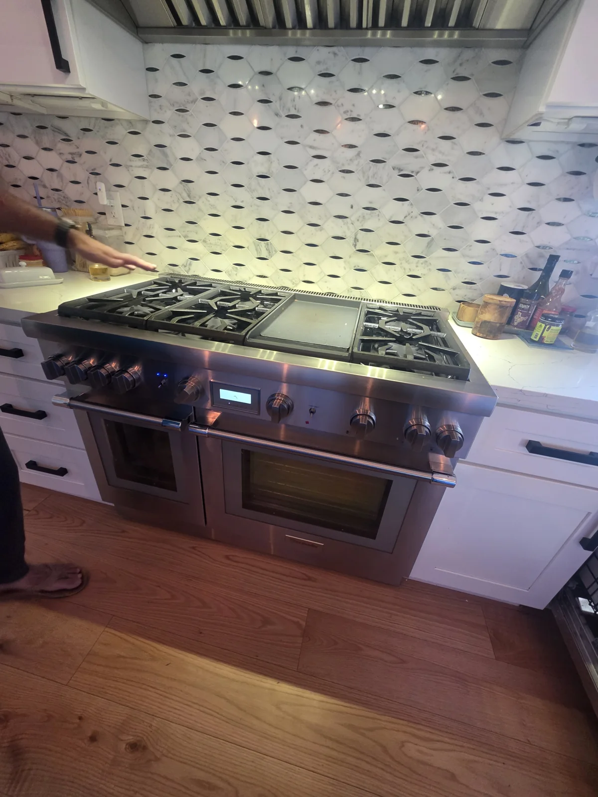 Thermador range beneath a kitchen hood