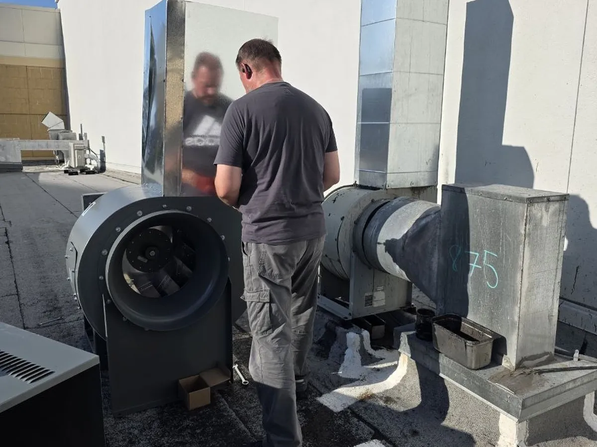 VOLT8 technician working on rooftop exhaust equipment
