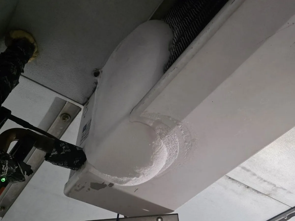 Insulated refrigerant line set running into a cold room