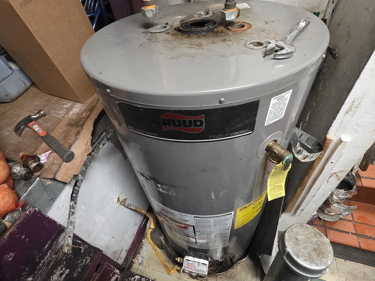 Gas storage water heater being serviced in a Bay Area home